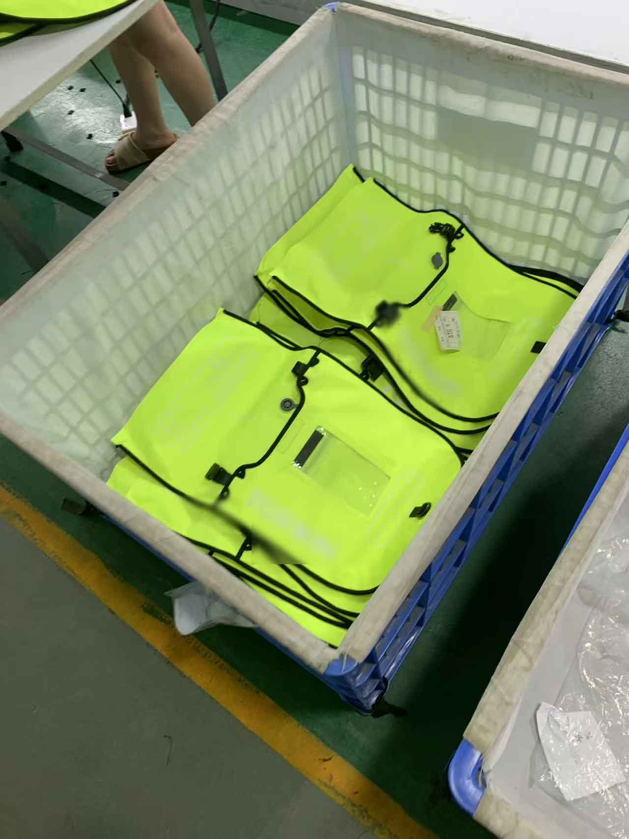 Finished swim buoys folded flat in a lined crate